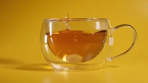 Sugar. Cubes of sugar are thrown into a cup of tea. Stock Footage 124519070