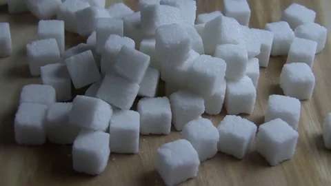Sugar cubes. Sugar cubes falls on the wooden board 動画素材 78232735