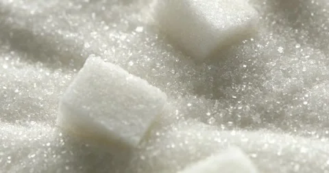 Sugar Cubes on the Surface of White Sugar. Macro. Close up. Slow motion. Stock Footage 242421411