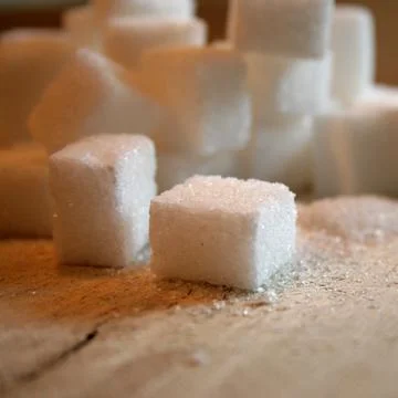 Sugar cubes on table Stock Photos
