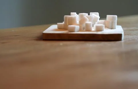 Sugar cubes on table Stock Photos