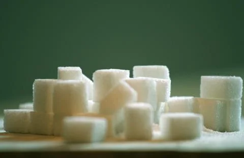Sugar cubes on table Stock Photos