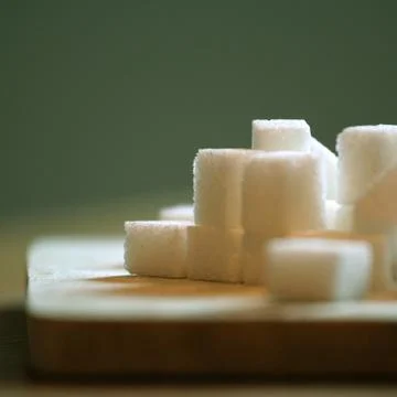 Sugar cubes on table Stock Photos