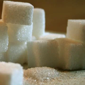 Sugar cubes on table Stock Photos