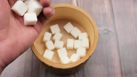Sugar cubes. White refined sugar. Sugar cubes in a wooden box. Sugar and hands. Stock Footage 171530342