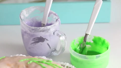 Sugar cupcake decorated with green elements. Near the icing of different colo Stock Footage 130603094