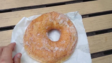 Sugar donut on a wooden table Stock Footage 334799515