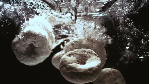 Sugar Donuts Fall in Water in Slow Motion Stock Footage 300892621
