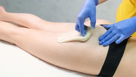 Sugar epilation of the buttock area of a young woman. sugaring Modern methods of Stock Footage 236085579