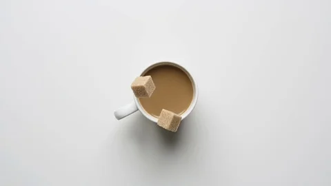 Sugar falling into coffee cup Stock Footage 120119351