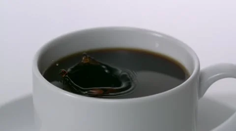 Sugar falling into cup of coffee, Slow Motion Stock Footage 10700796