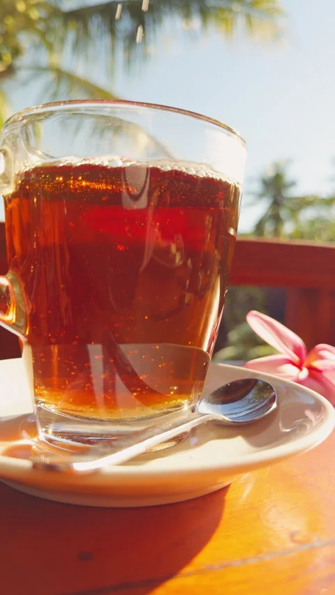 Sugar Falling Into Hot Tea Creating Swirling Patterns And Sparkling Bubbles In S Stock Footage 336811839
