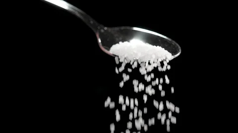 Sugar falling from the spoon in dark studio. Slowmotion, 180 fps shot Stock-Footage 86283353