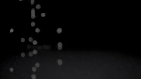 Sugar falling on the table in dark studio. Slowmotion, 180 fps shot Stock Footage 86284071
