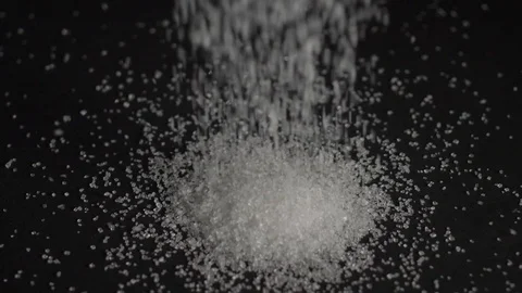 Sugar falls on a black background Stock Footage 106707806