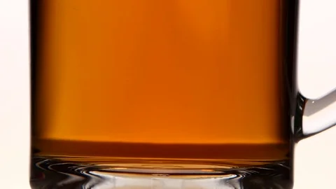 Sugar falls to the bottom of cup tea. Close ups Stock Footage 73849522