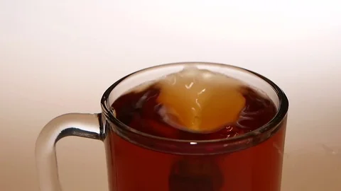 Sugar falls to the bottom of cup tea. Top view Stock Footage 73855312