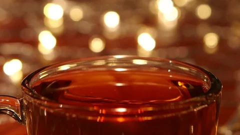 Sugar fast drops into hot black tea in close ups Stock Footage 73634576