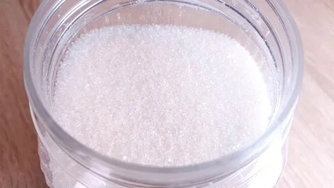 Sugar in a jar. Sugar consumption, white granulated sugar. Calories of sugar. Stock Footage 311049986