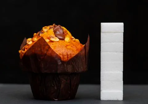 Sugar level next to the cupcake, cubes sugar stacked on top of each other, th Stock Photos