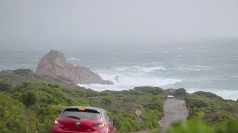 Sugar loaf rock cold front car driving past in slow motion Video stock 204929299