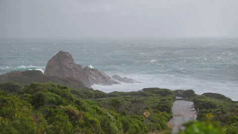 Sugar loaf rock cold front raining large swell and surf slow motion Stock-Footage 204929819