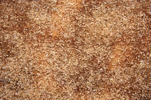Sugar mixed with cinnamon scattered on the surface of the table. Stock Photos