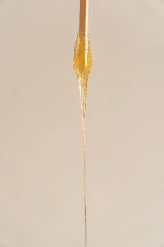 Sugar paste flowing down drop close-up vertical photo Stock Photos