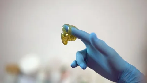 Sugar paste on a hand in blue glove. Poster, copy space. Sugaring salon Stock Footage 251650057