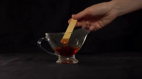 Sugar paste for shugaring on a black background 4k video Stock Footage 162792989