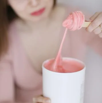 Sugar paste for sugaring depilation close up photo with model hands Stock Photos