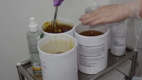 Sugar paste. Sugaring, depilation. Smooth skin legs. Waxing with sugar. Stock Footage 89063679
