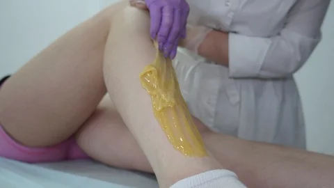 Sugar paste. Sugaring, depilation. Smooth skin legs. Waxing with sugar. Stock Footage 89063733