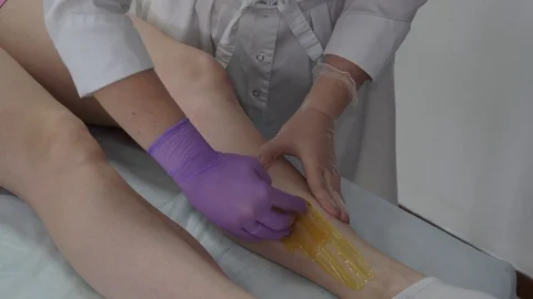 Sugar paste. Sugaring, depilation. Smooth skin legs. Waxing with sugar. Stock Footage 89063785