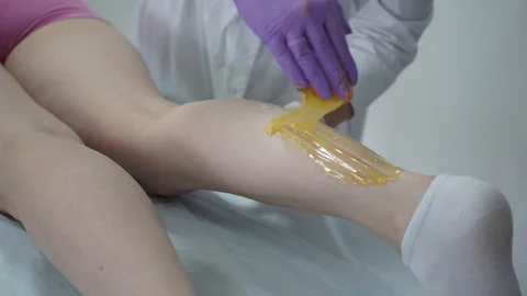 Sugar paste. Sugaring, depilation. Smooth skin legs. Waxing with sugar. Stock Footage 89063831