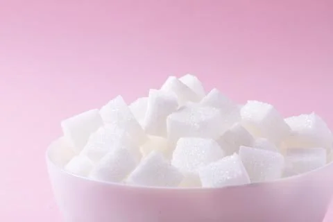 Sugar on pink background Stock Photos
