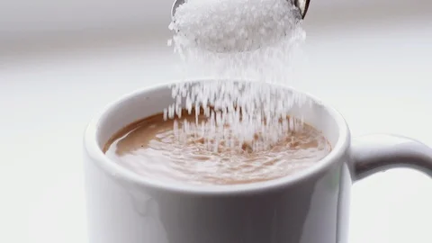 Sugar poured into coffee Stock Footage 85849650