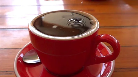 Sugar is poured into a cup of coffee Stock Footage 121652681