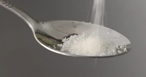 Sugar is poured into a spoon. Close-up. Stock Footage 249595714
