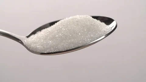 Sugar is pouring Slow motion from teaspoon on white Background Stock Footage 111804280