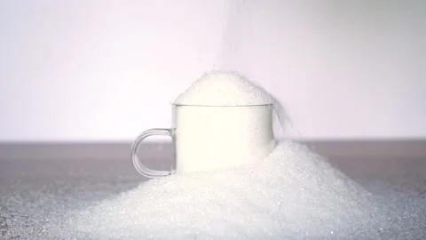 Sugar pours into a full mug Stock Footage 168465697