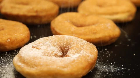Sugar powder falling on a doughnuts Stock Footage 50593190