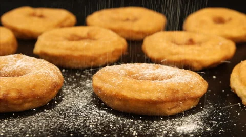Sugar powder falling on a doughnuts, Tracking Stock Footage 50593218