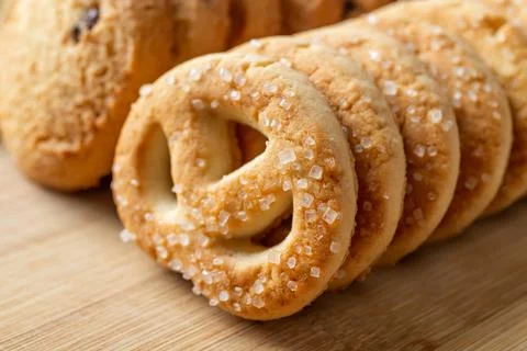 Sugar pretzel macro. Crispy shortbread pretzels with sugar in a row. Stock Photos