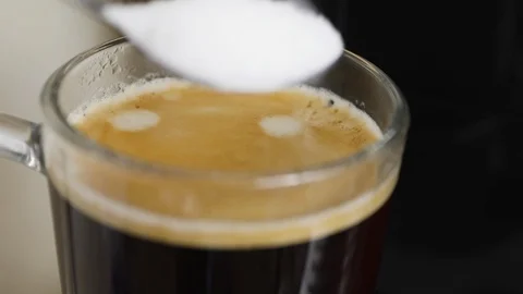 Sugar is put in coffee Stock Footage 125895676
