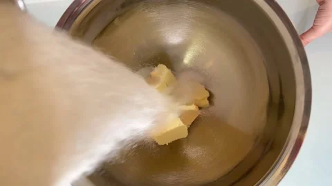 Sugar is put in the dish with butter Video stock 230077897