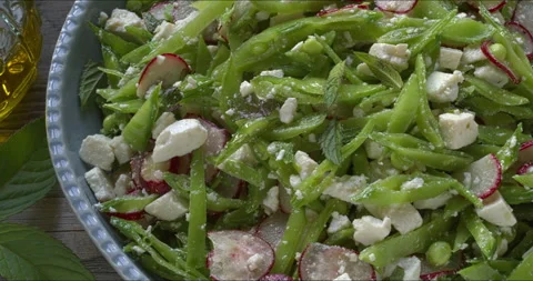 Sugar snap pea and radish salad. Camera slide. Video stock 312330191