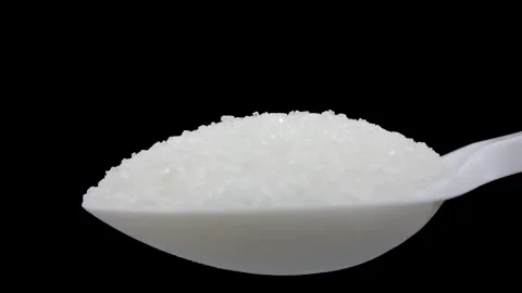 Sugar in a spoon on a black background close-up. White sugar close-up. Stock Footage 194672567