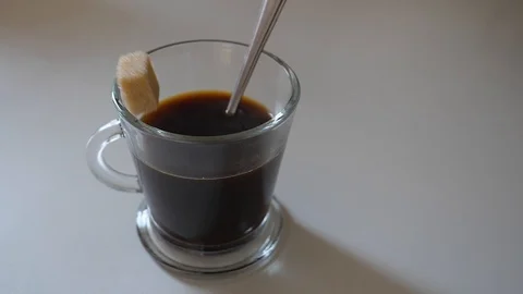 Sugar stone falling into coffee cup in slow-motion (200fps) 스톡 동영상 125568002