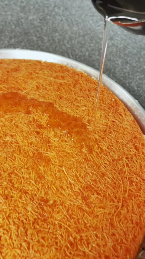 Sugar Syrup Pouring Over Kunafa Pastry Stock Footage 341716972